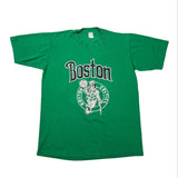 A green short-sleeve Boston Celtics t-shirt with a vintage-style graphic on the front featuring the team name and logo, laid flat on a white background.
