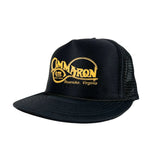 Black trucker cap with yellow logo and text on a white background