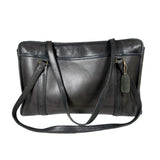 Black leather handbag with a shoulder strap on a white background