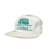 White cap with green text and logo on a gray background