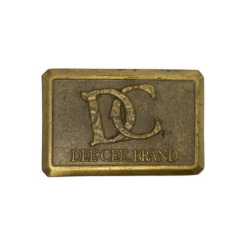Brass belt buckle with 'DEE CEE BRAND' logo on a white background