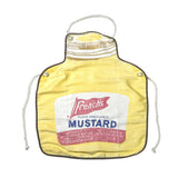 A vintage French's mustard-themed fabric apron in pale yellow, featuring a printed white mustard label with red and blue lettering, metal grommets, and white drawstring cords on a light gray background.