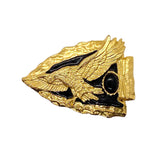 Gold and black decorative item on a white background