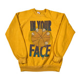 Yellow sweatshirt with graphic design and text on a white background