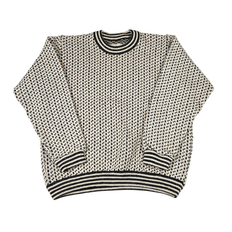 Black and white patterned sweater on a white background