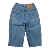 Back view of light blue denim cropped jeans with a raw frayed hem, laid flat on a white background.