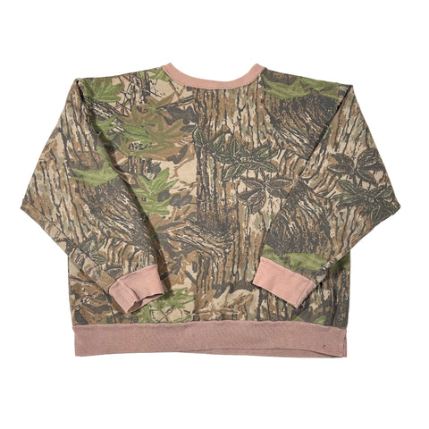 Camouflage-patterned sweater with pink accents on a white background