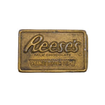 Brass Reese's Peanut Butter Cups candy bar on a white background