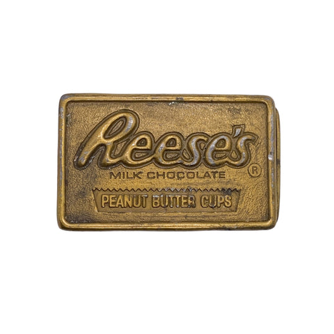 Brass Reese's Peanut Butter Cups candy bar on a white background