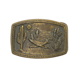 Bronze belt buckle with desert scene design on a white background