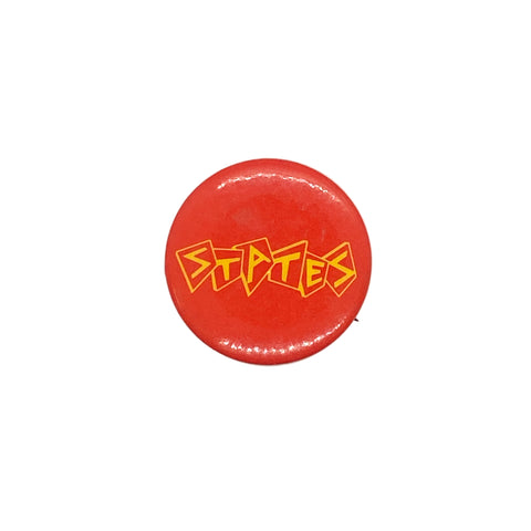 Red button with yellow text on a white textured background