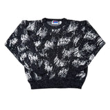 Black and white patterned sweater on a white background