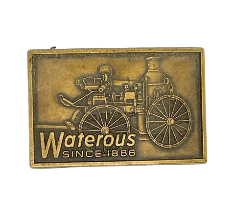 Bronze plaque with a vintage fire engine design and 'Waterous Since 1886' text on a white background