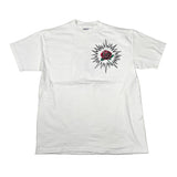 White t-shirt with a rose and starburst design on a light gray background