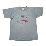 A faded gray short-sleeve t-shirt with a graphic print of a horse, a red tank, and dog paw prints on a white background.