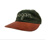 Green cap with brown visor and 'Hogan' embroidery on a white background
