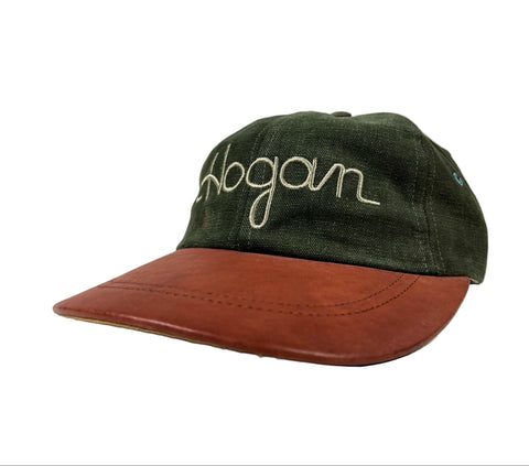 Green cap with brown visor and 'Hogan' embroidery on a white background