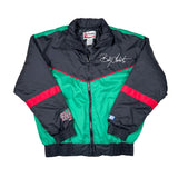 A vintage Interbay jacket laid flat on a white background. The jacket features a black upper section and sleeves, a bright green lower body panel, and red stripe accents.