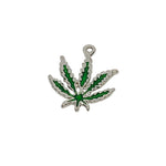 Silver pendant with green leaf design on a white textured background