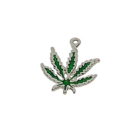 Silver pendant with green leaf design on a white textured background