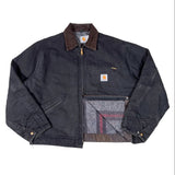 Dark denim jacket with Carhartt logo on a white background