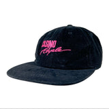 A dark navy blue baseball cap made of a textured canvas-like fabric, featuring bright pink embroidered text on the front that reads 'CASINO Royale'. The cap is photographed on a clean, light gray-to-white studio background.