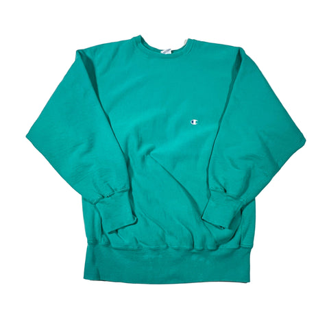 Teal shorts with a small logo on a white background
