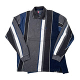 A long-sleeve polo shirt laid flat on a light background, featuring vertical stripes in gray, navy blue, black, and white, with a small embroidered logo on the chest.