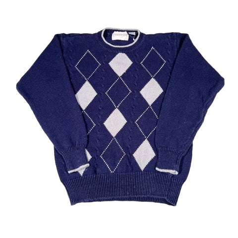 Navy blue sweater with white diamond pattern on a white background