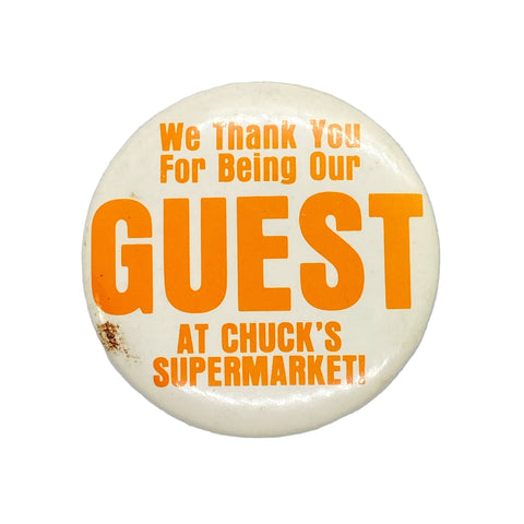 Button badge with orange text on a white background