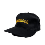 Black cap with yellow text 'Richmond' on a white background