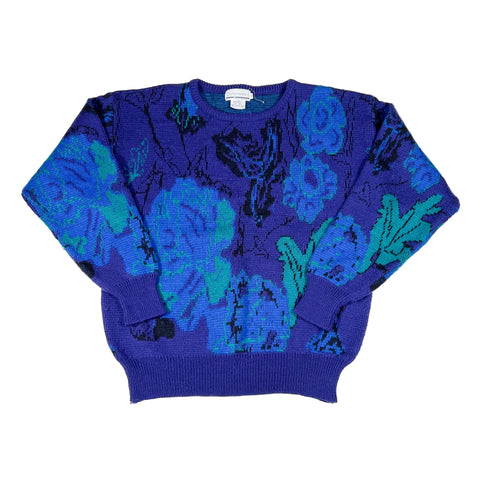 Blue sweater with floral pattern on a white background