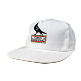 White cap with black eagle design and 'Cuervo Tradicional' logo on a gray background