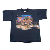 A vintage black short-sleeve t-shirt featuring a large graphic print of a stag deer in a colorful forest landscape, laid flat on a white surface.
