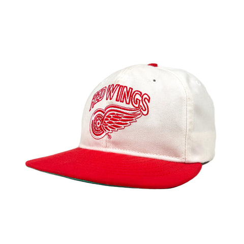 White and red cap with 'Red Wings' logo on a white background