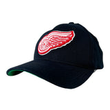 A dark navy blue baseball cap featuring a prominent red and white embroidered Detroit Red Wings logo on the front, set against a clean white background.