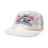 White cap with text and graphics on a gray background