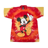 A vintage Mickey Mouse tie-dye t-shirt featuring a large graphic of Mickey on the front, set against a red, orange, and yellow spiral tie-dye pattern with yellow sleeves.