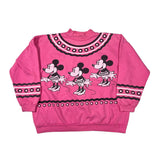 A pink crewneck sweatshirt featuring three cartoon Minnie Mouse figures across the front, decorated with black and white geometric patterns along the collar, cuffs, and hem.