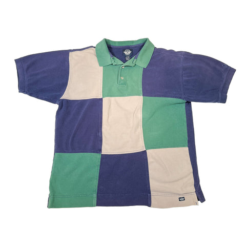 Color-blocked polo shirt with purple, green, and beige squares on a white background
