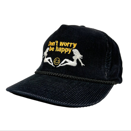 Black cap with 'Don't worry be happy' text and smiley face design on a white background