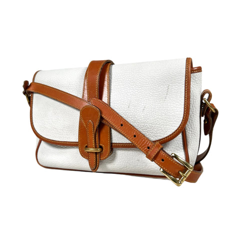 White handbag with brown leather straps on a white background