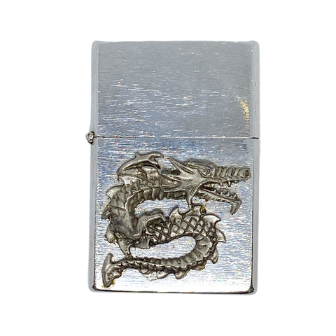 Silver lighter with dragon design on a white background