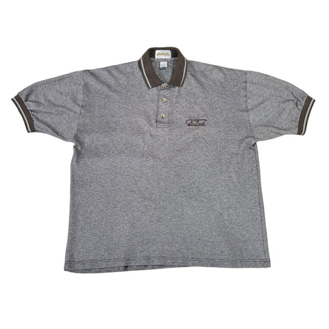 Gray polo shirt with a GT BMX logo on a white surface