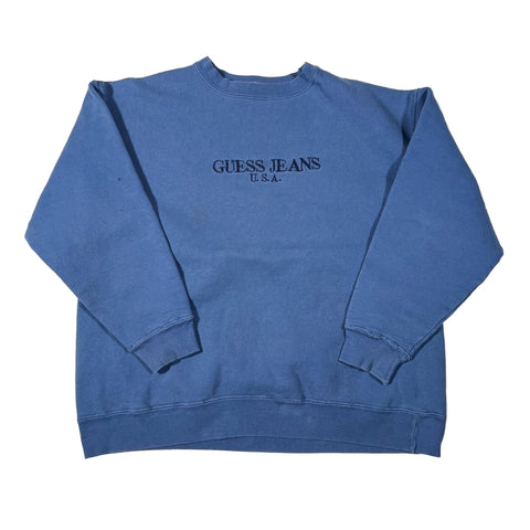 Blue sleeveless shirt with Guess Jeans logo on a white background