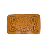Brown leather belt buckle with embossed design on a white background