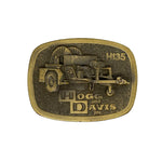 Brass belt buckle with Hogg and Davis Inc. logo on a white background