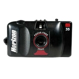 A vintage black Horizon 35mm film camera with red and white branding details, photographed on a light gray textured background.
