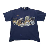 A navy blue long-sleeve t-shirt laid flat on a white fabric background, featuring a graphic print of five wolves in various colors on the front.