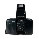 Black Kodak camera with flash on a white background